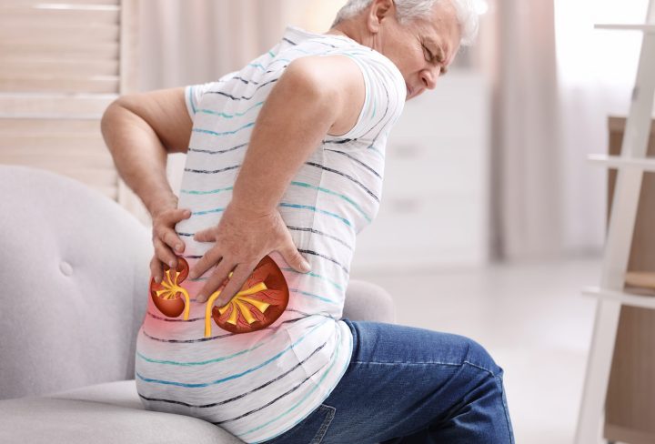 Senior man suffering from kidney pain at home